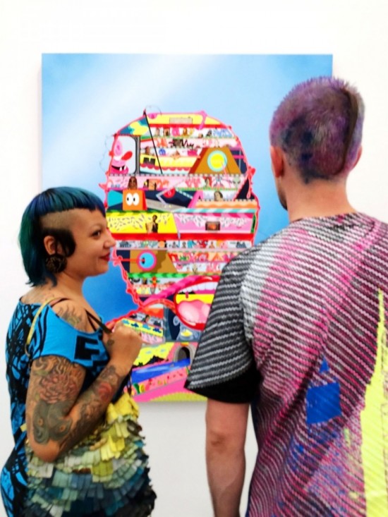 Colourful couple in front of colourful artwork 